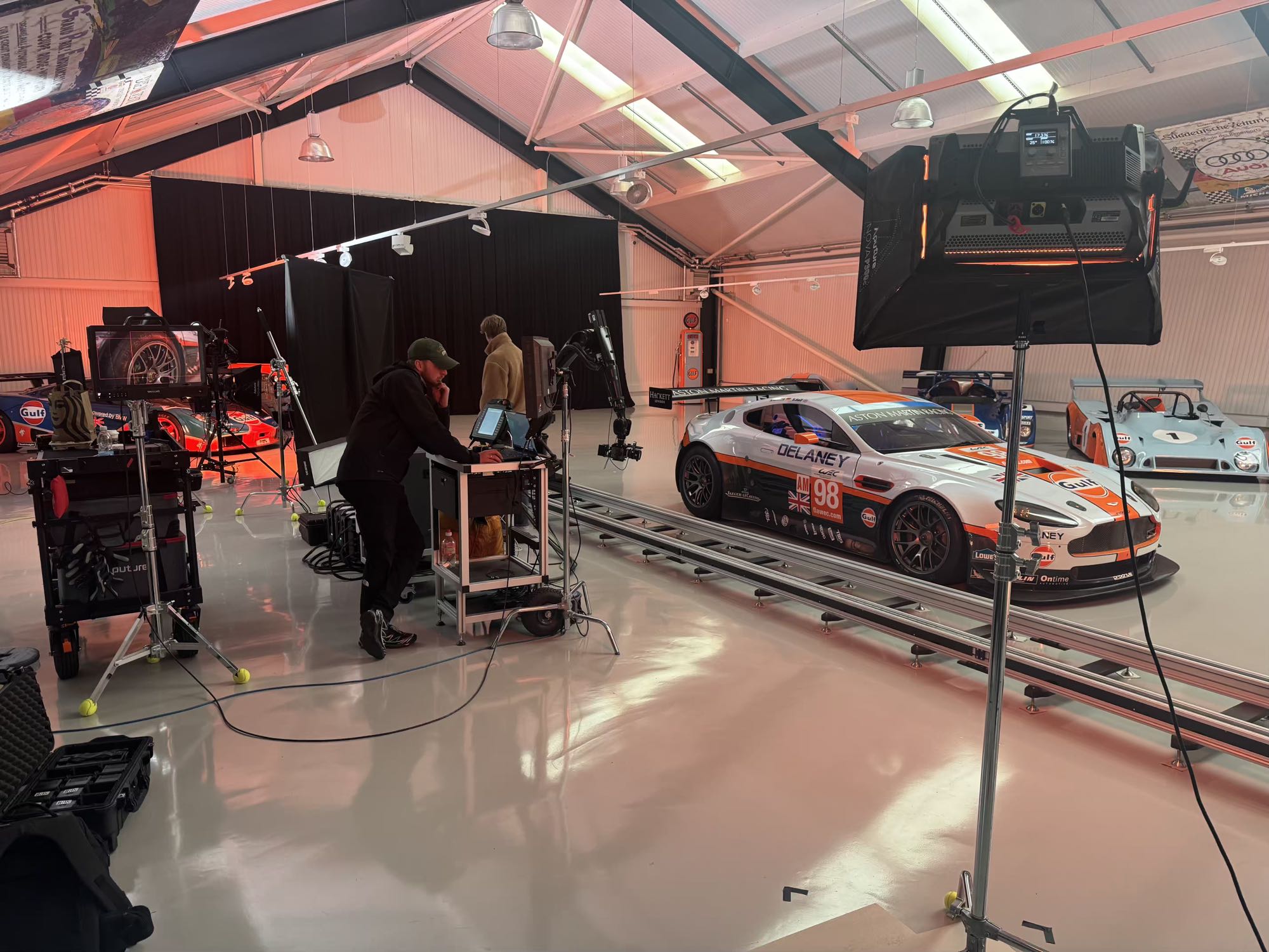 Wide view of the IRIS shoot: crew at the monitor cart, the robot on track, and the Gulf collection ranked behind