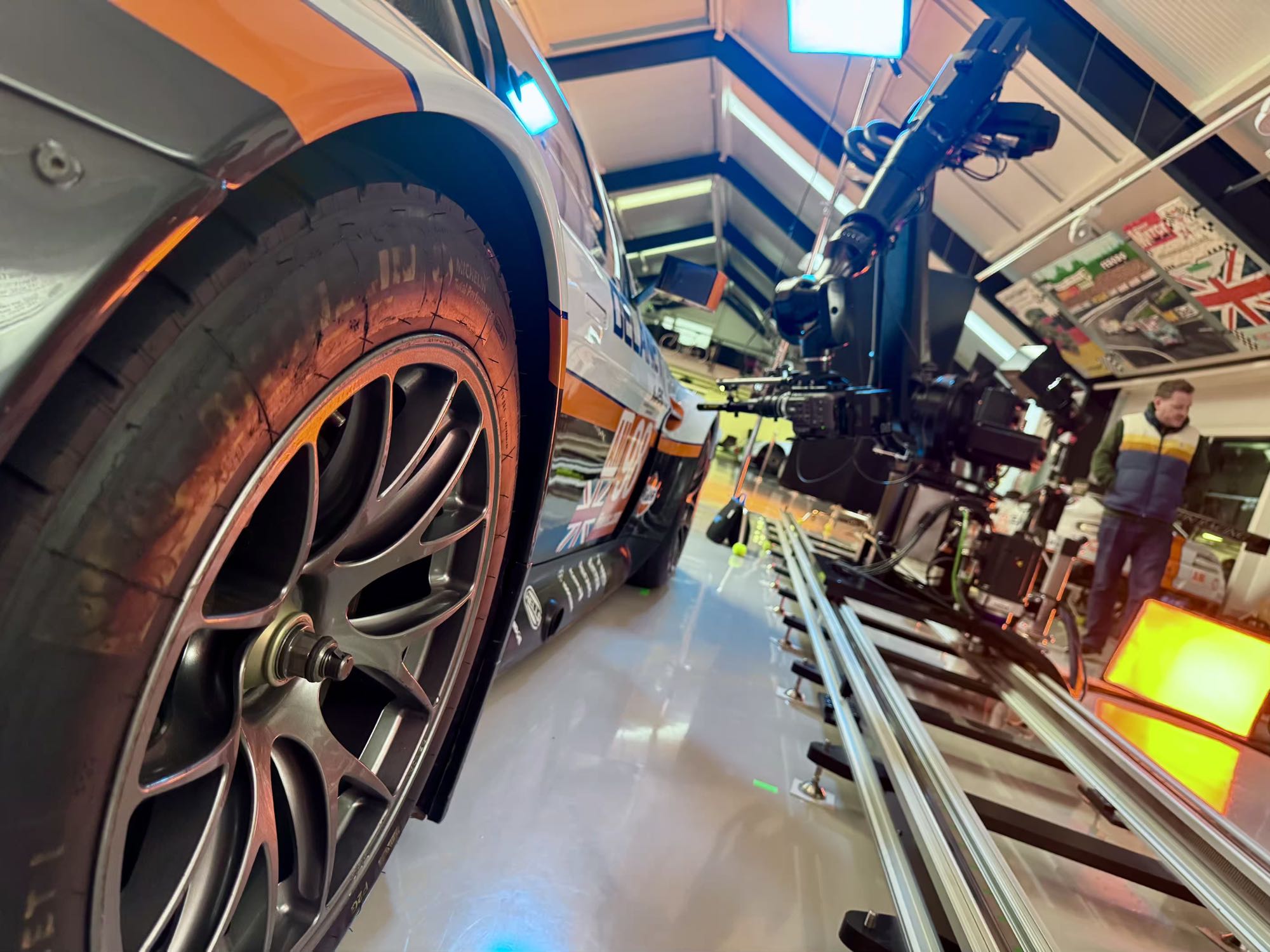 Low-angle detail of the Gulf Aston Martin GTE wheel with the robot and camera tracking alongside