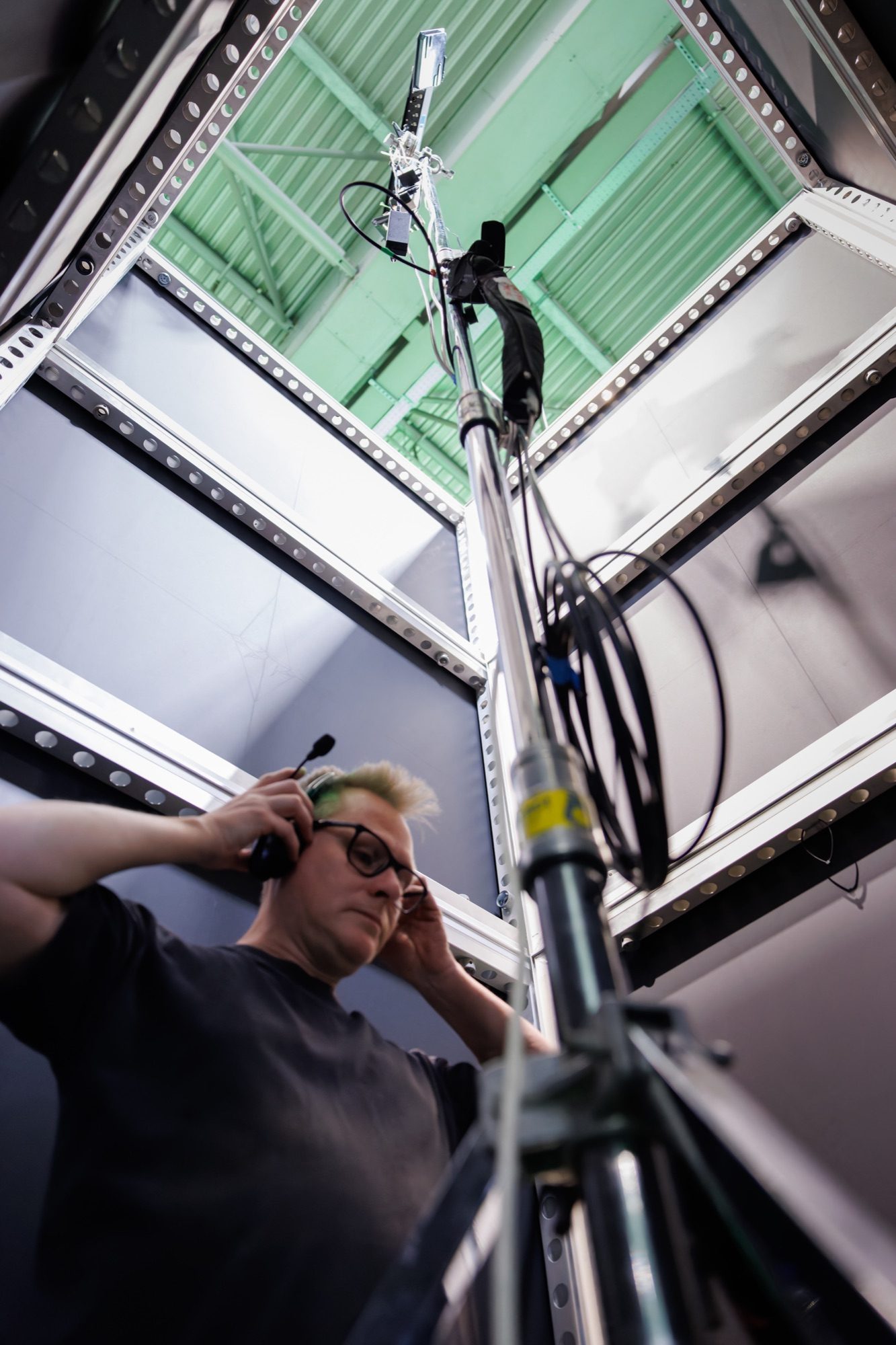 A crew member on comms inside the LED stage structure