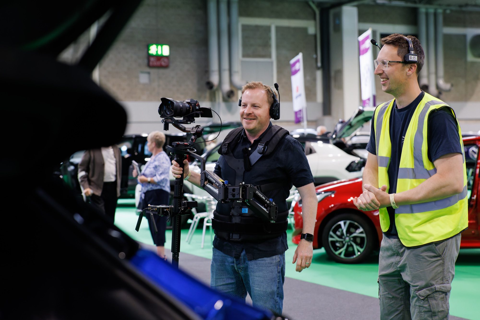 Two of the crew sharing a laugh between takes on the show floor