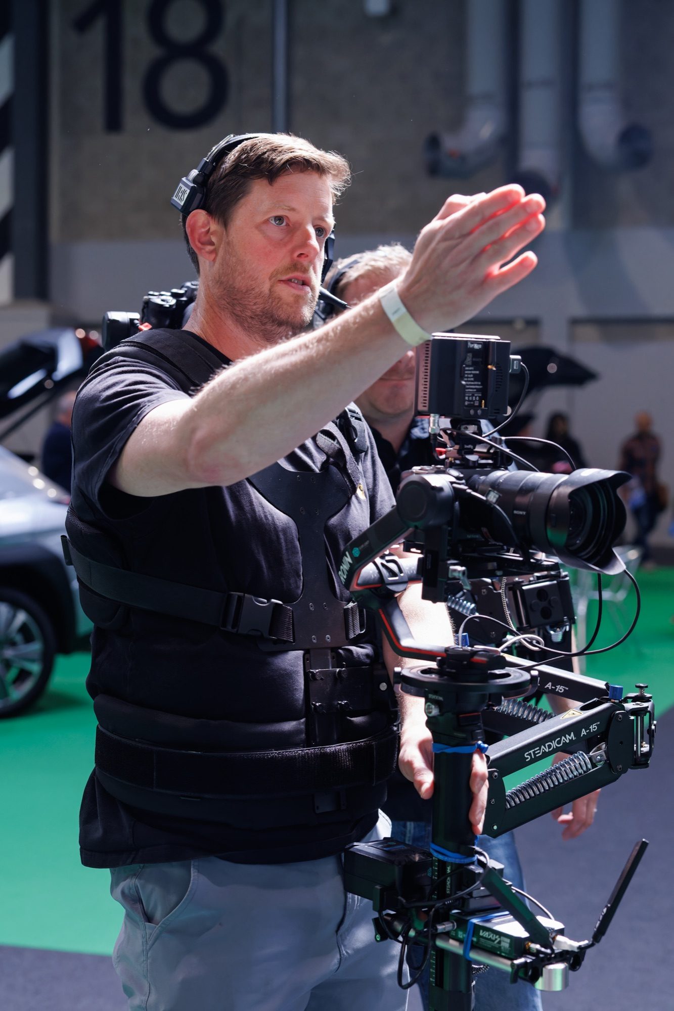A camera operator directing a shot on a Steadicam rig