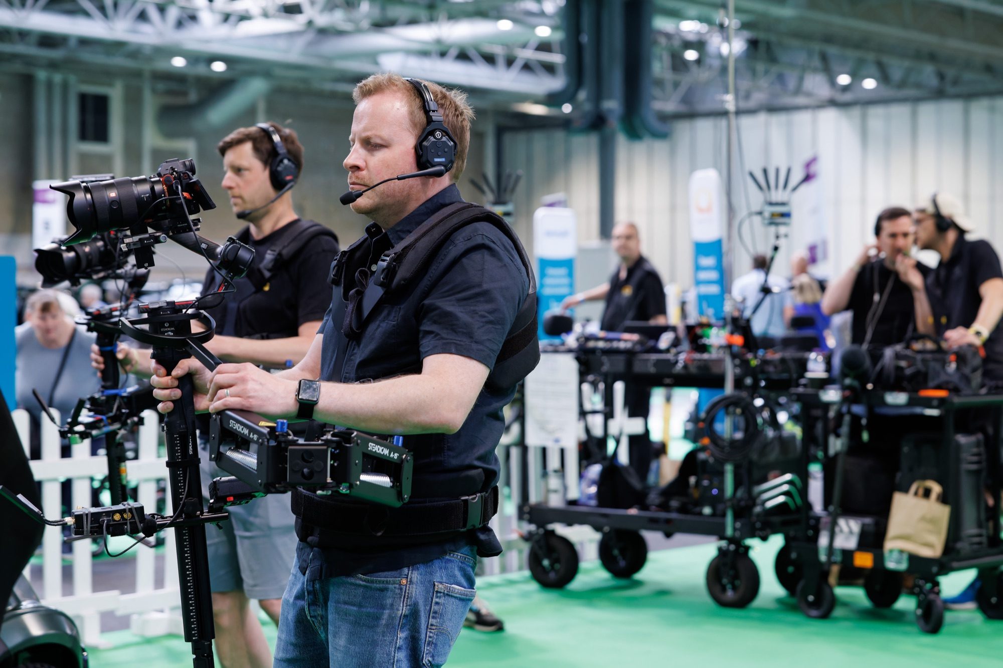 Two Steadicam operators lined up to cover the floor, equipment carts behind