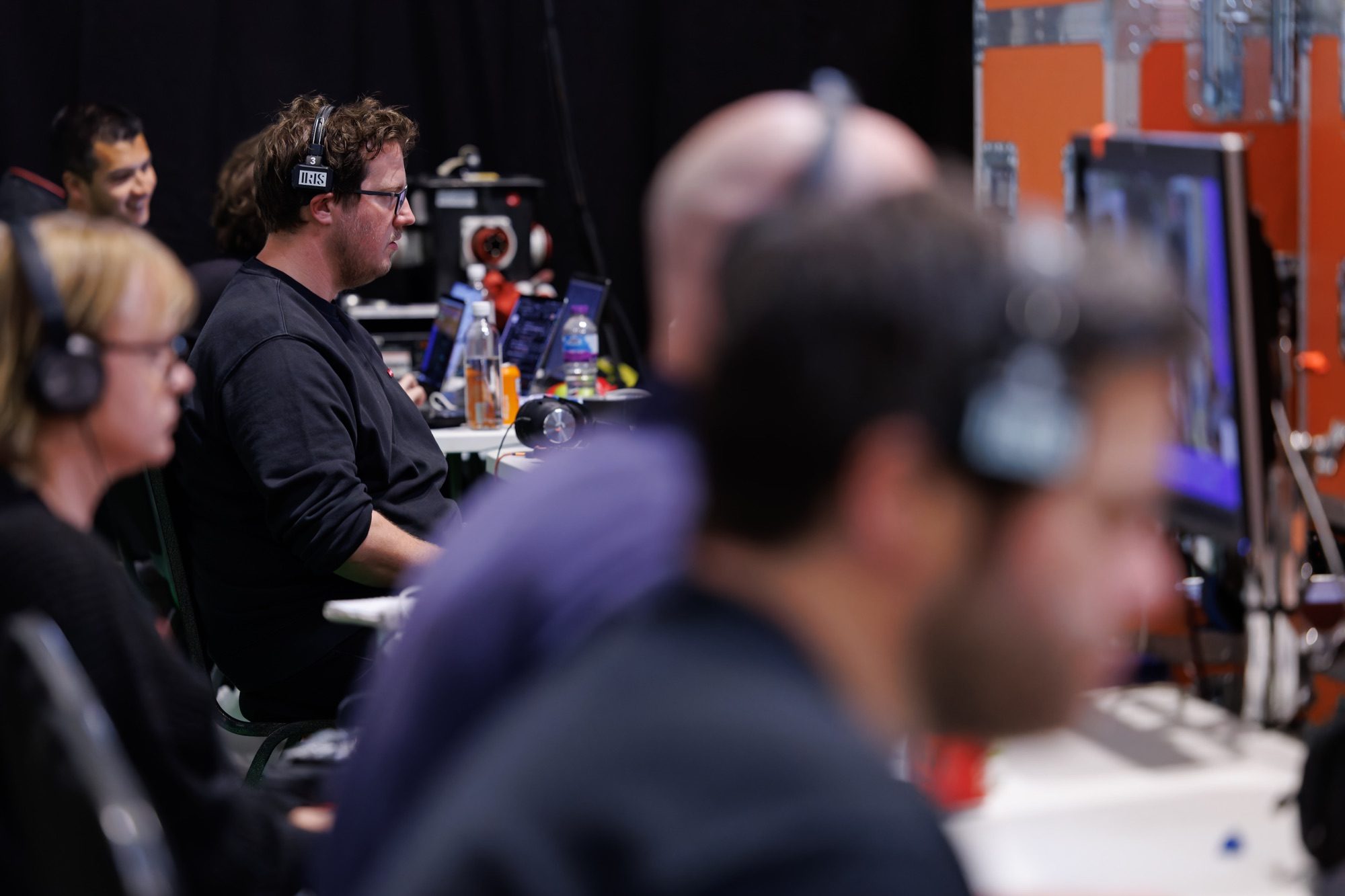 The gallery team monitoring the live output on headphones
