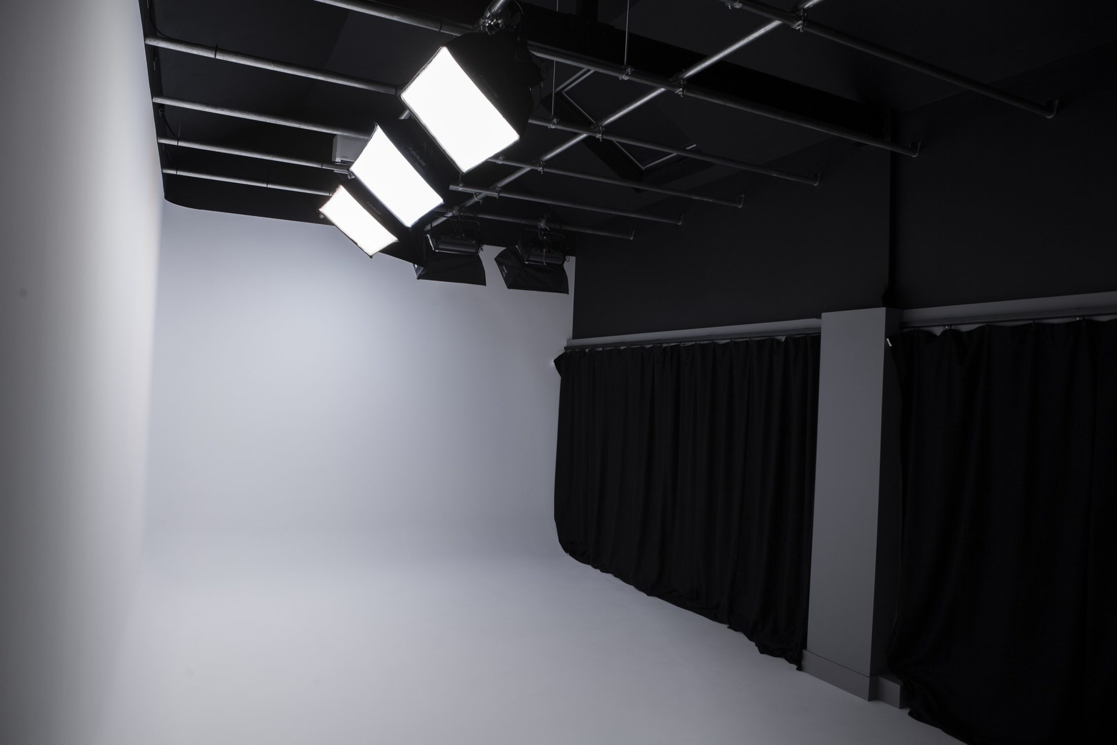 The IRIS studio at Brickendonbury: a white infinity cove under a ceiling lighting rig, with blackout drapes along the far wall
