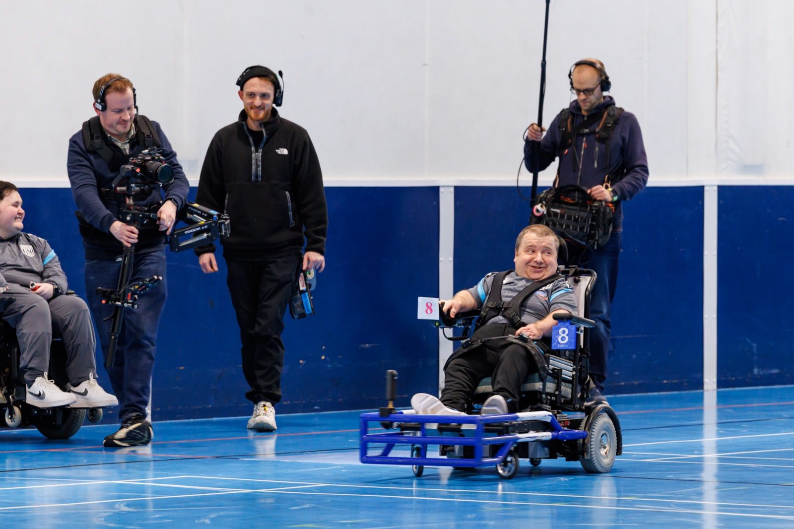 Filming David at powerchair football training in the sports hall